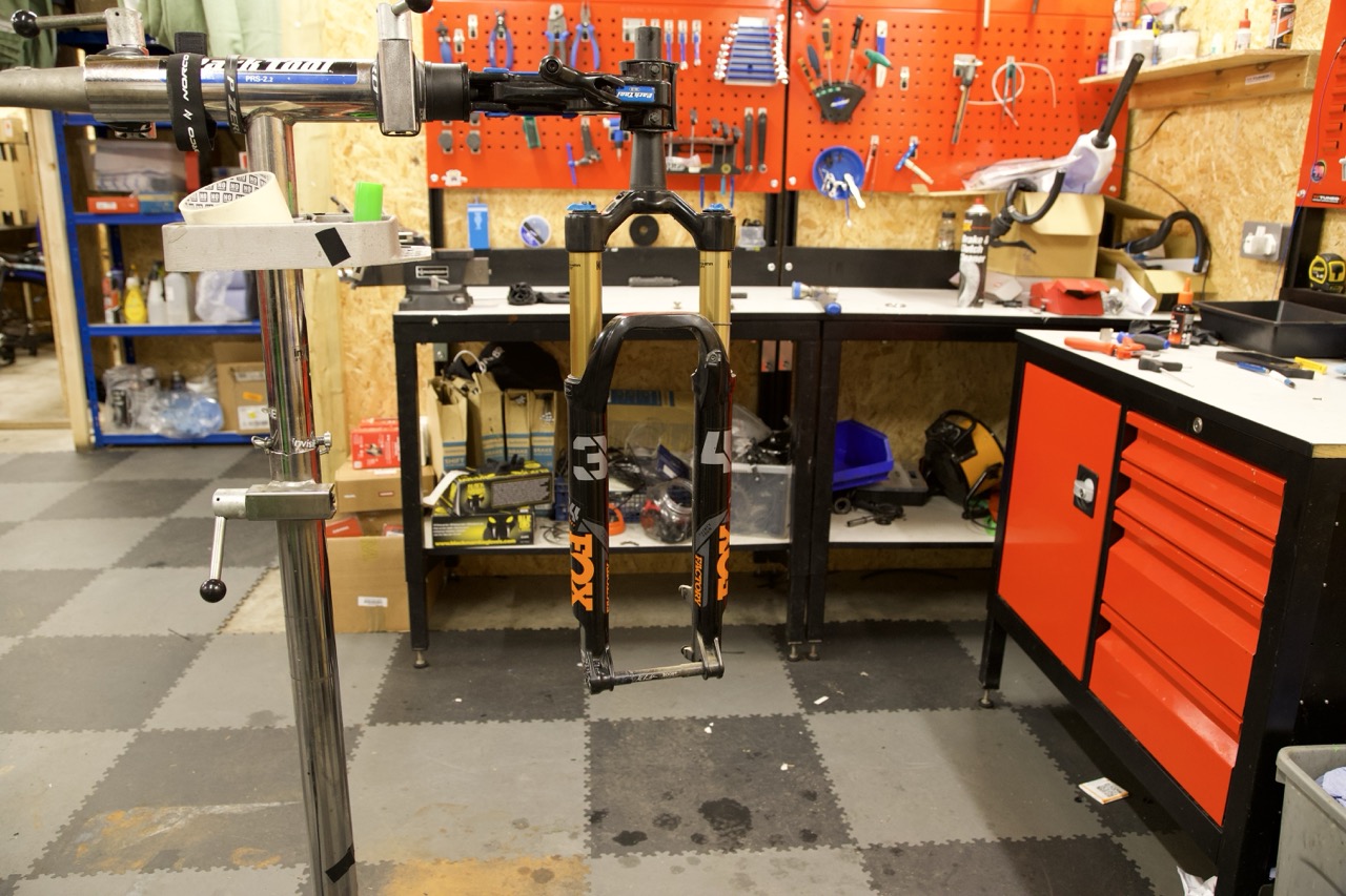 Fox fork lowers in the workshop stand during service